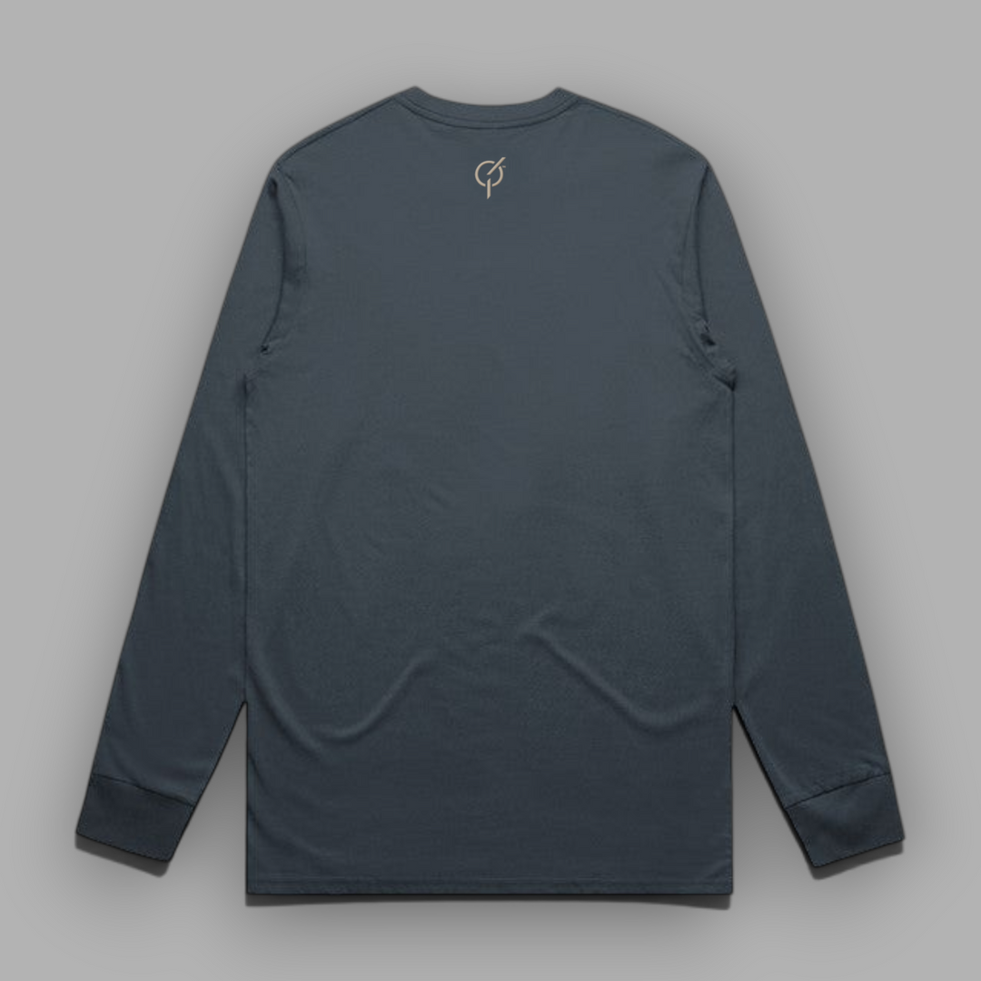 Back view of a petrol blue long-sleeve cotton tee with the signature Core Emblem embroidered in sand-colored thread below the back collar.