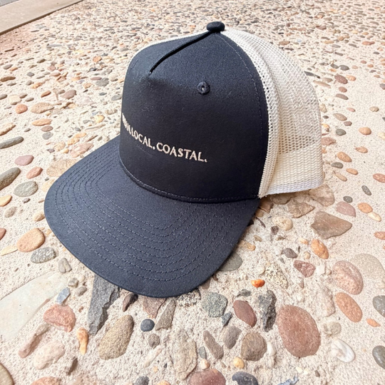 area 609 The Founders trucker hat in black cotton with an ecru mesh back, flat peak, and signature front embroidery.