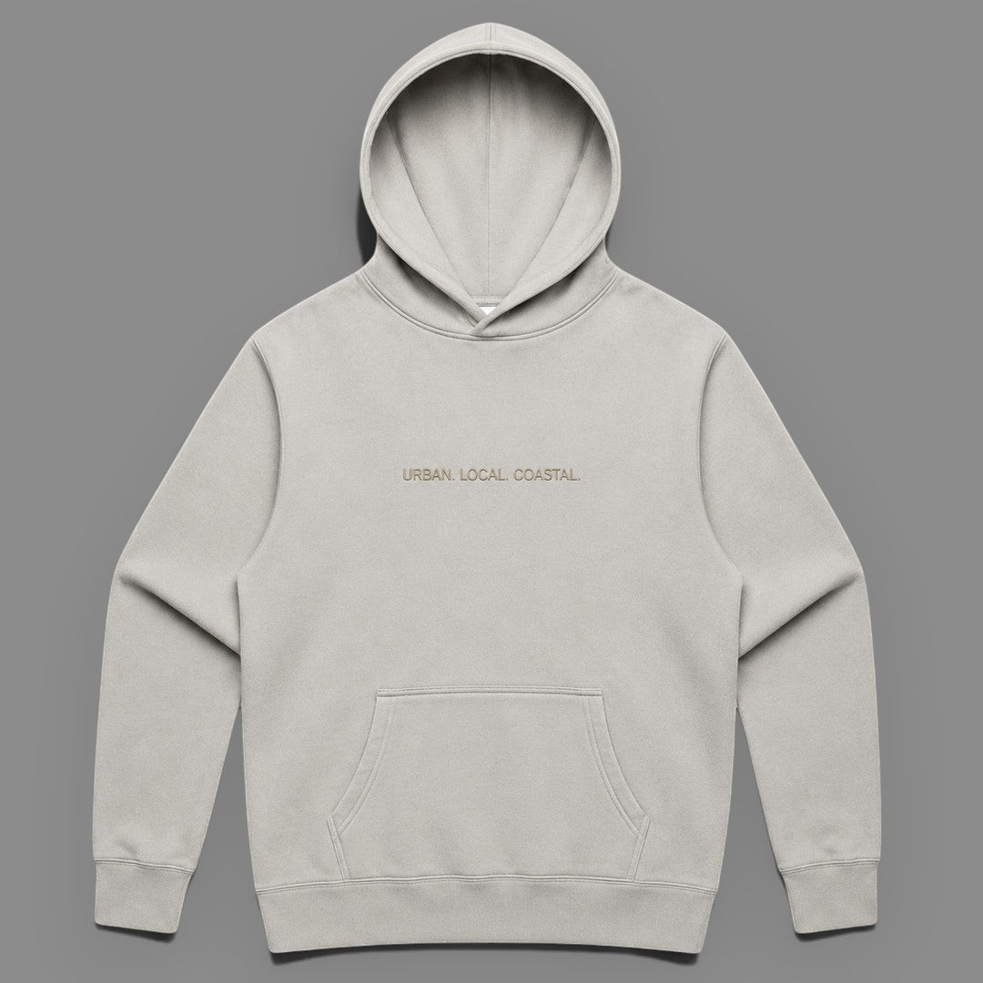 area 609 The Core Hoodie in faded bone cotton-blend fleece with drop shoulders, kangaroo pocket, and embroidery.