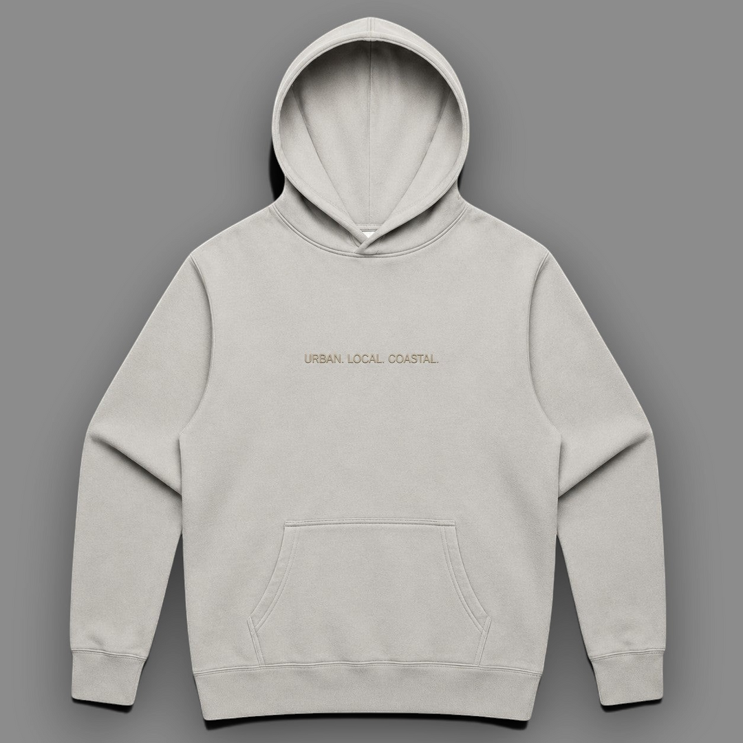 area 609 The Core Hoodie in faded bone cotton-blend fleece with drop shoulders, kangaroo pocket, and embroidery.