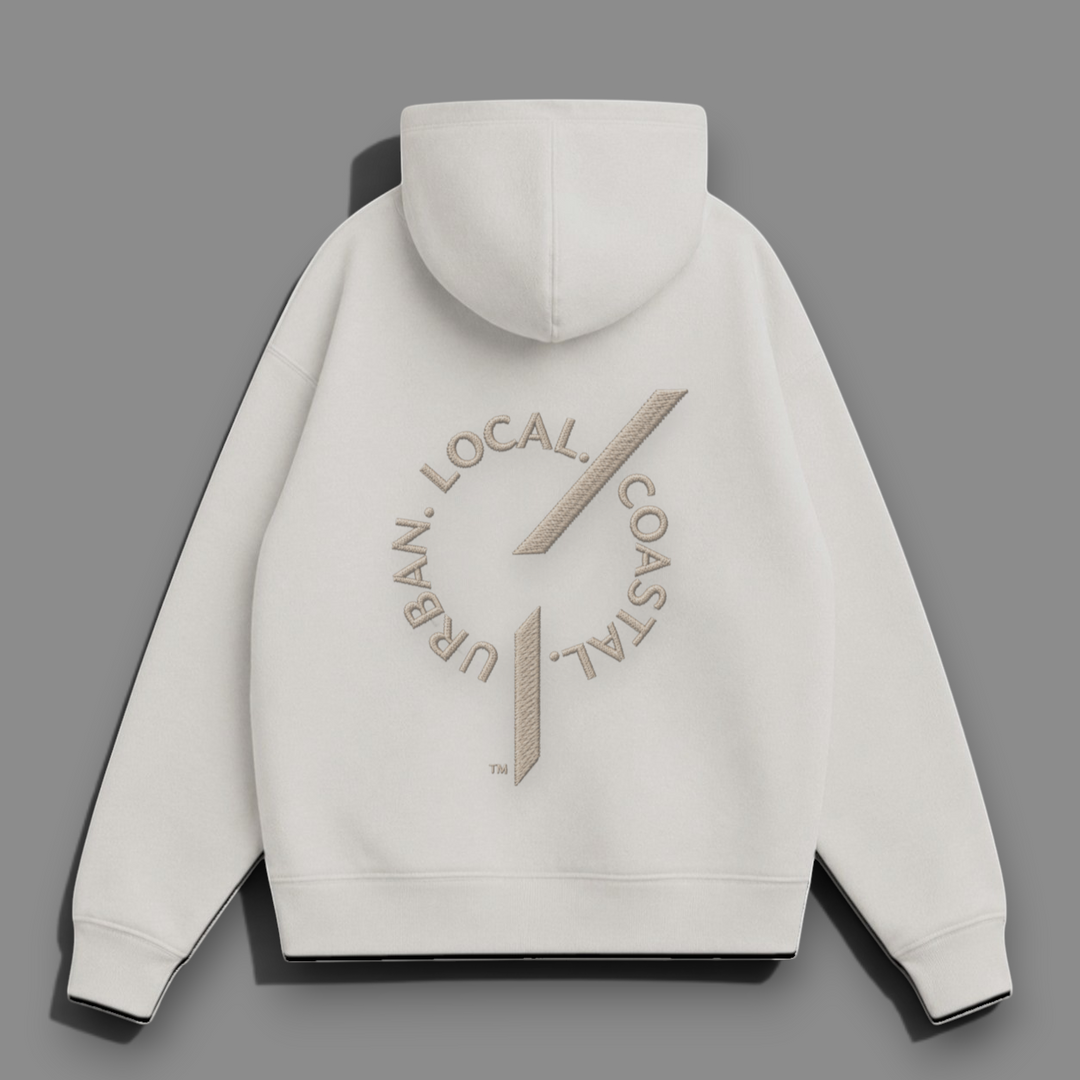 Back view of an area 609 The Founders Hoodie in parchment organic French terry with embroidered logo detail.