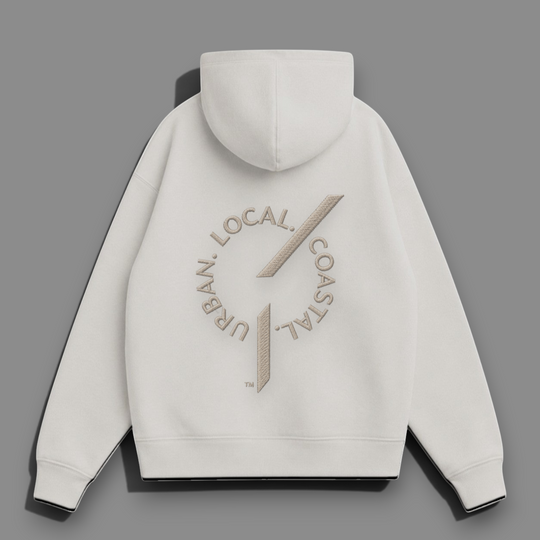 Back view of an area 609 The Founders Hoodie in parchment organic French terry with embroidered logo detail.