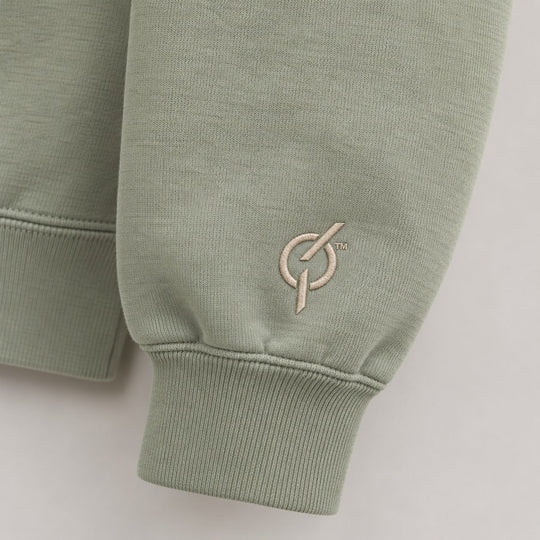 area 609 sage green crewneck sweatshirt sleeve featuring a detailed embroidered logo on the ribbed cuff