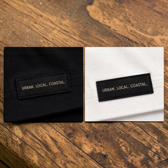 area 609 The Founders V Neck cotton shirt featuring a black woven hem label with Urban Local Coastal text